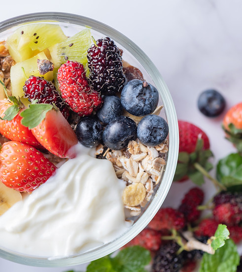 bowl-oat-granola-with-yogurt-fresh-blueberries-mulberry-strawberries-kiwi-banana-mint-nuts
