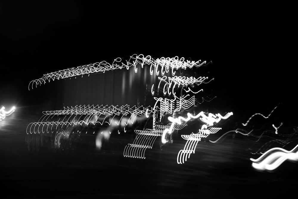 An ICM intentional camera movement photograph of a truck at night with bright lights taken by Megan Kennedy at IRIS28