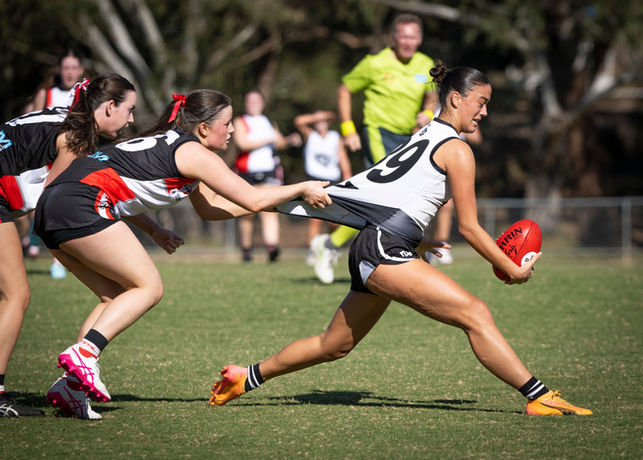 A players jumper being stretched while tackled