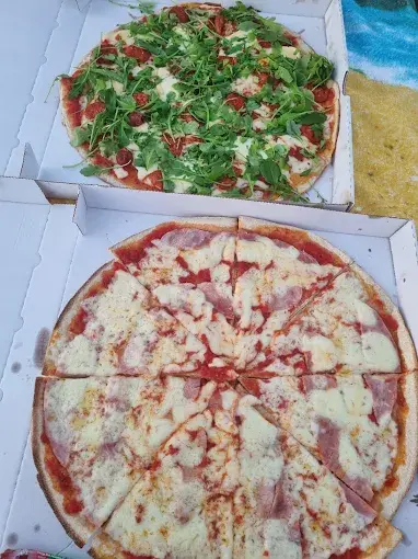 Vue rapprochée d'une pizza artisanale à emporter avec garnitures colorées