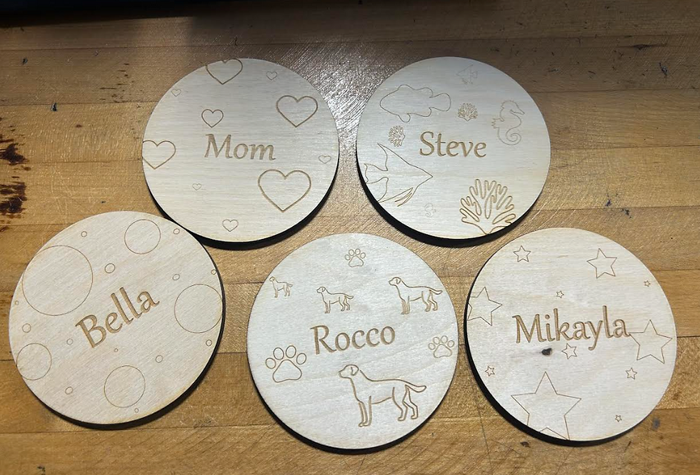 All five coasters cut out in wood and sanded down.