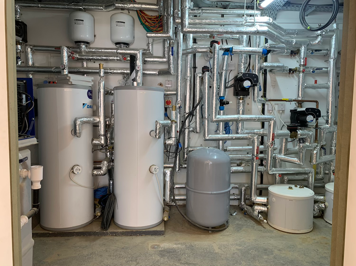 DAIKIN cascade Air source heat pump installation plant room with hot water cylinders.