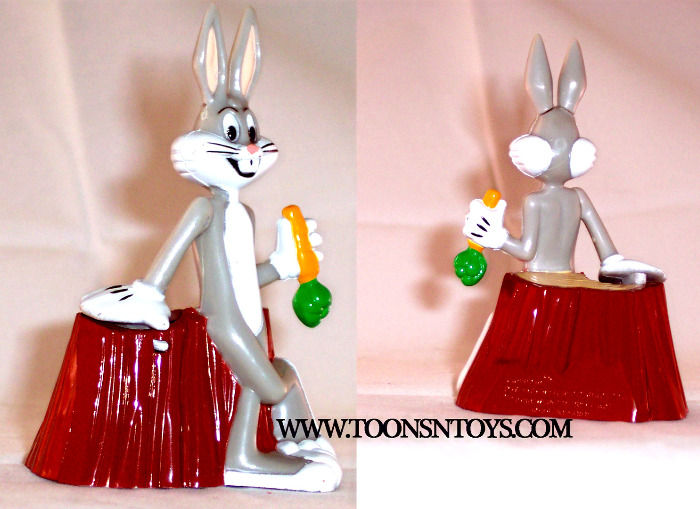 The Bugs Bunny plastic gumball figure is posing on a tree stump. Back posed