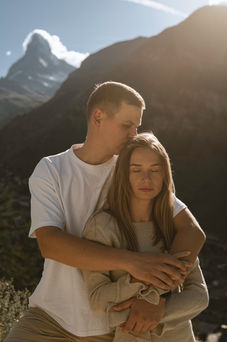 The Matterhorn peeks out of the background of a man and woman in love