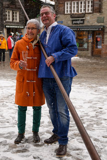 a couple smiles as he holds an alphorn