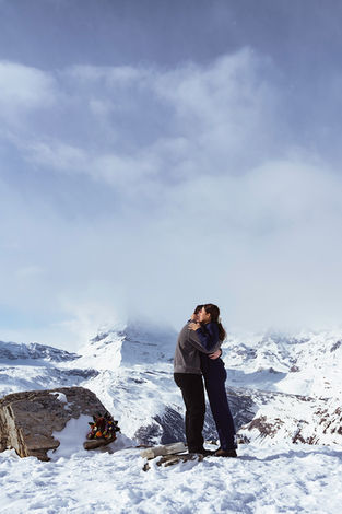 Two people hugging outside in the snow