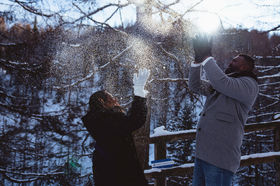 two people throwing snow up in the air