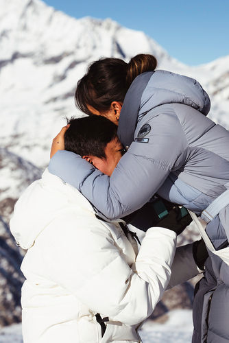 a woman hugging her fiancé's face right after he proposed