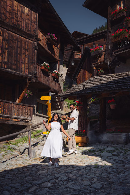 couple between old larch-wood houses in Grimentz