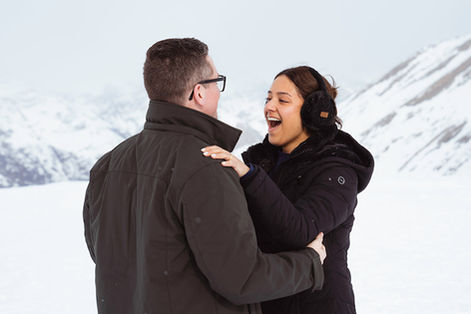 a woman looks at her partner surprised that he just proposed