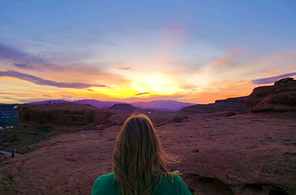 author on top of a bluff viewing a sunset