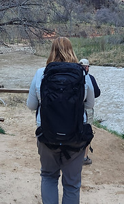 Author hiking in Zion with a large pack on her back