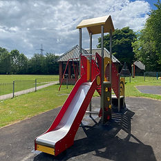 A children’s play area at Hampden Playpark in Wendover with a slide, climbing frame and open green space