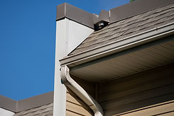 new-rain-gutter-home-against-blue-sky-roof-wall.jpg