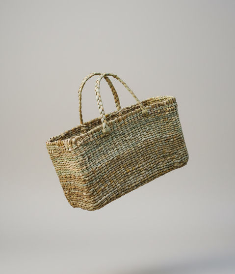 Flat woven handbag made from natural reed.