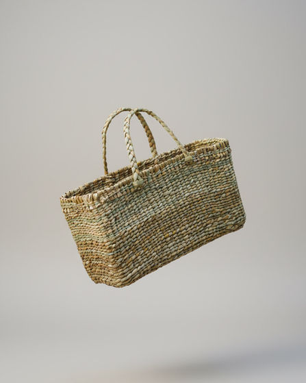 Flat woven handbag made from natural reed.