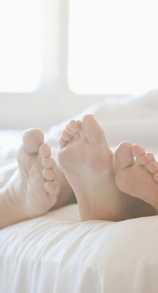 Couple's Feet in Bed