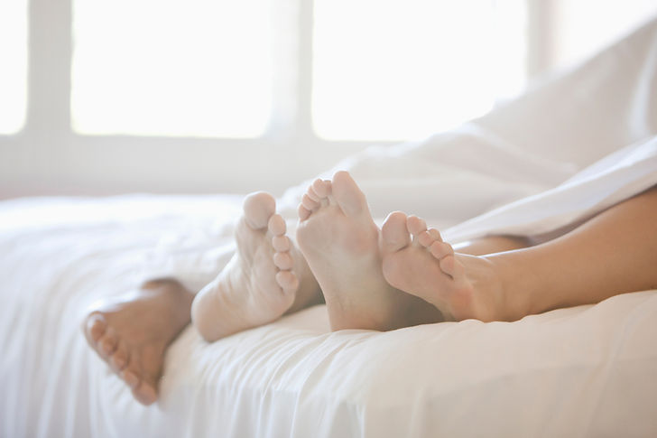 Couple's Feet in Bed