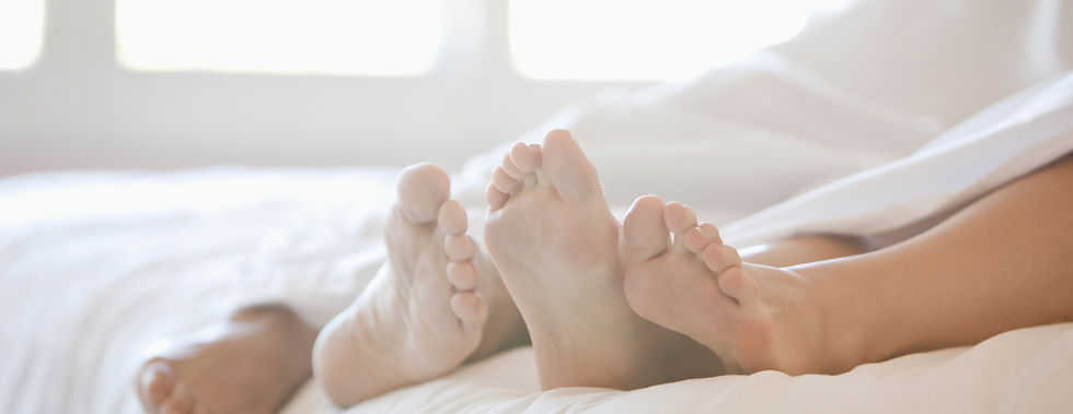 Couple's Feet in Bed