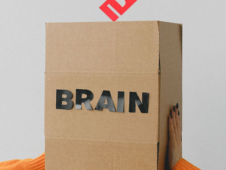 An idea being placed into a box that has the word brain written on it