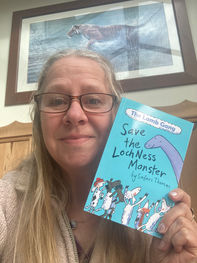 Safari Thomas holding her Book, The Lamb Gang save the Loch Ness Monster