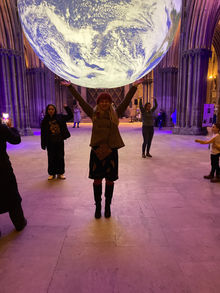 Safari Thomas at Lichfield Cathedral, UK holding planet Earth 