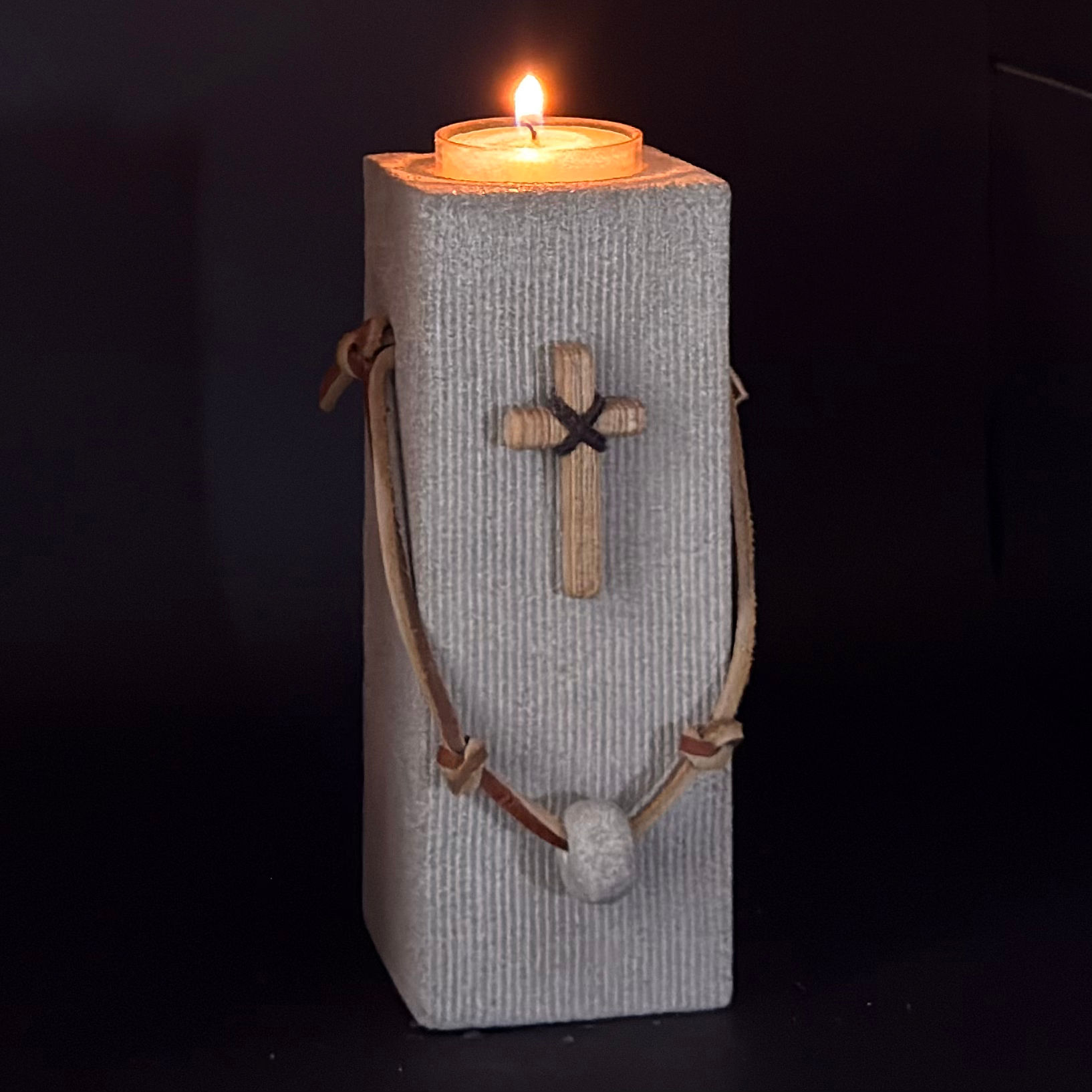Hand carved Indiana limestone with leather strap cross candle holder.