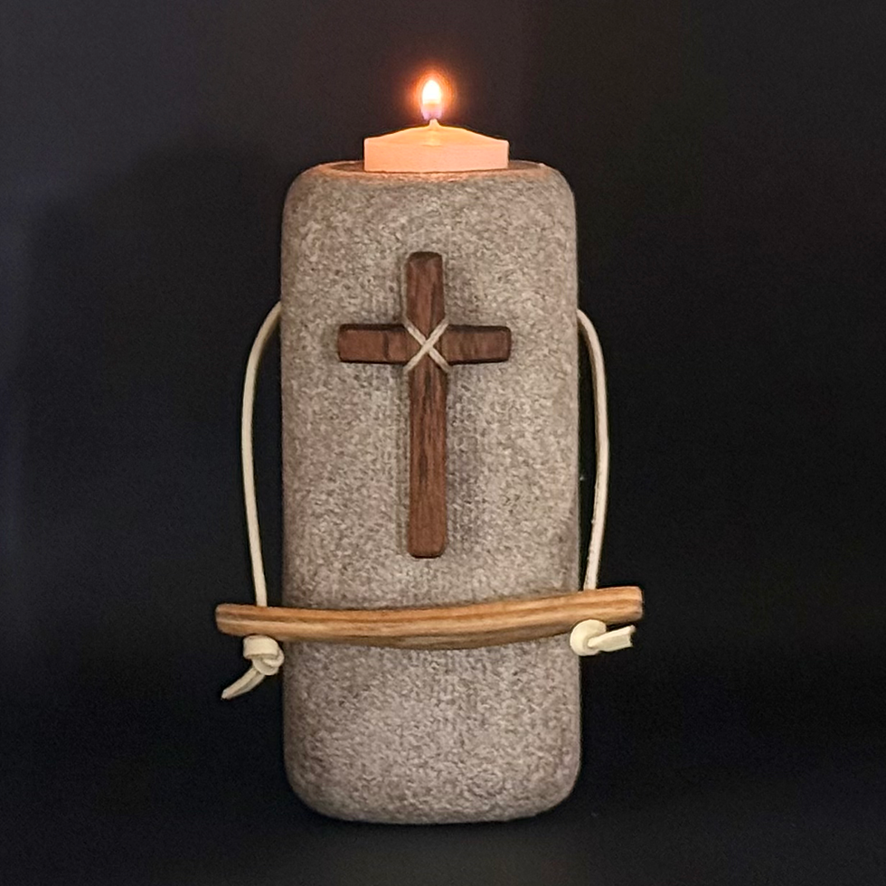 The Held is a 5' limestone sculpture that is light gray in color. There is a cross fashioned by hand out of Iowa hardwood and a leather bound handle attached to the front.
