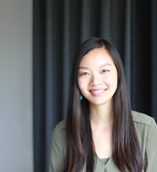Vickie Wang Headshot, East Asian woman with long, side-parted straight black hair, wearing an army green shirt.JPG