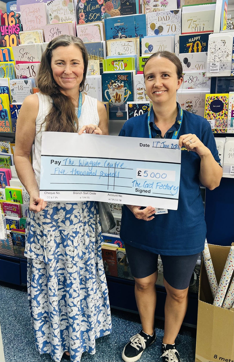 Rhiannon Vine, the Wingate's Trust Fundraiser, accepting a £5,000 cheque from Laura at Card Factory, Nantwich