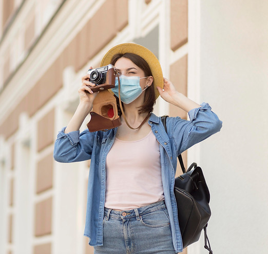 woman-with-hat-and-face-mask-taking-pict