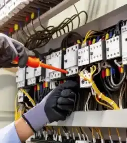 Electrician testing electrical panel wiring safety