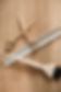 Golden haircutting scissors and white comb on wood.