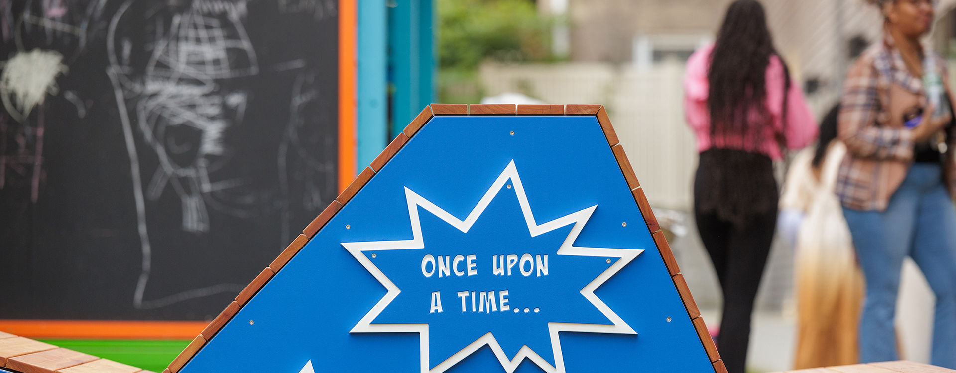 Close up of a Playful Learning bench with three large multi-pointed stars framing prompts like: "Once upon a time"