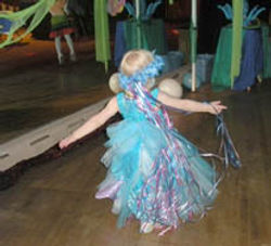 Twirling child in a fancy dress at a birthday party