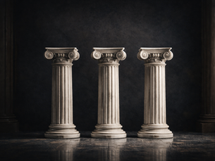 Imagem de três colunas de estilo clássico, feitas de pedra ou mármore, dispostas em linha em um ambiente com fundo escuro e piso de pedra.
