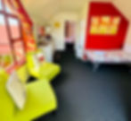 single bed and two green chairs