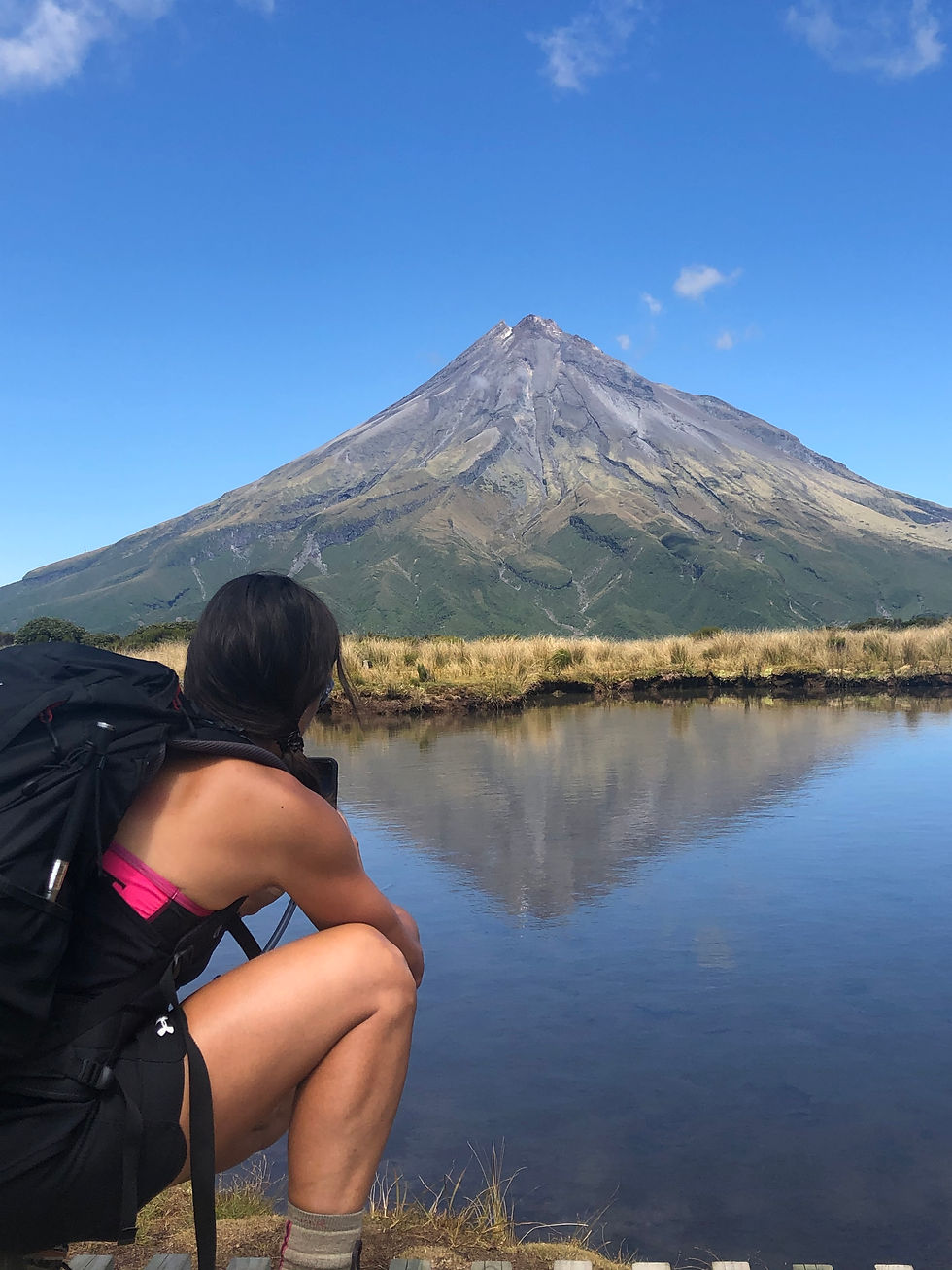 climber looking across lake to mountain