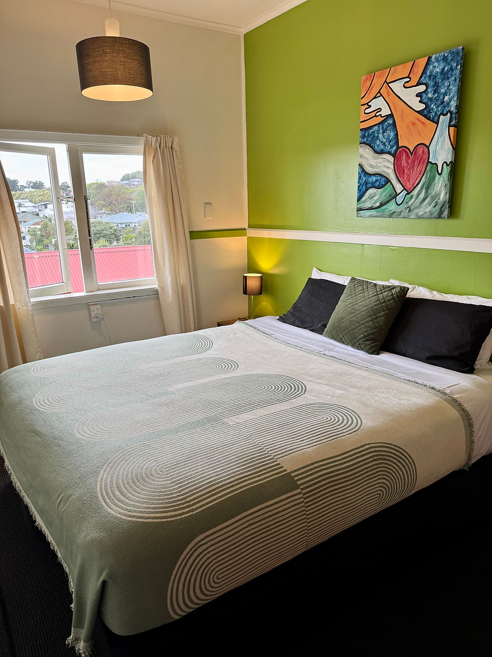 double bed in room with green wall