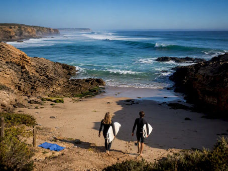 Surfers entering a sheltered Portuguese cove