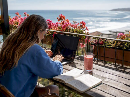 Woman planning surf school trip at kitchen table