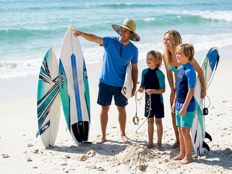 Family discussing surfing terms together at beach