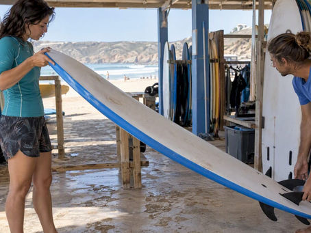 Beginner checking a rental surfboard’s size
