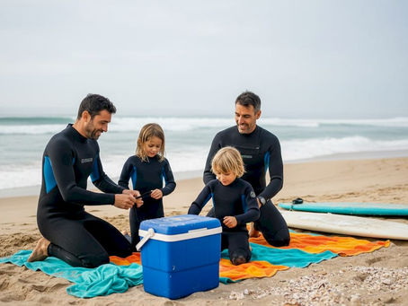 Family prepares surfboards on Portugal beach
