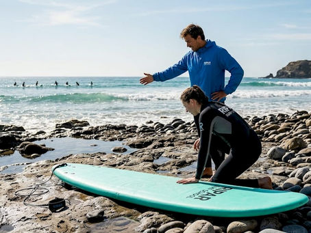 Beginner surfer learning on sandy beach