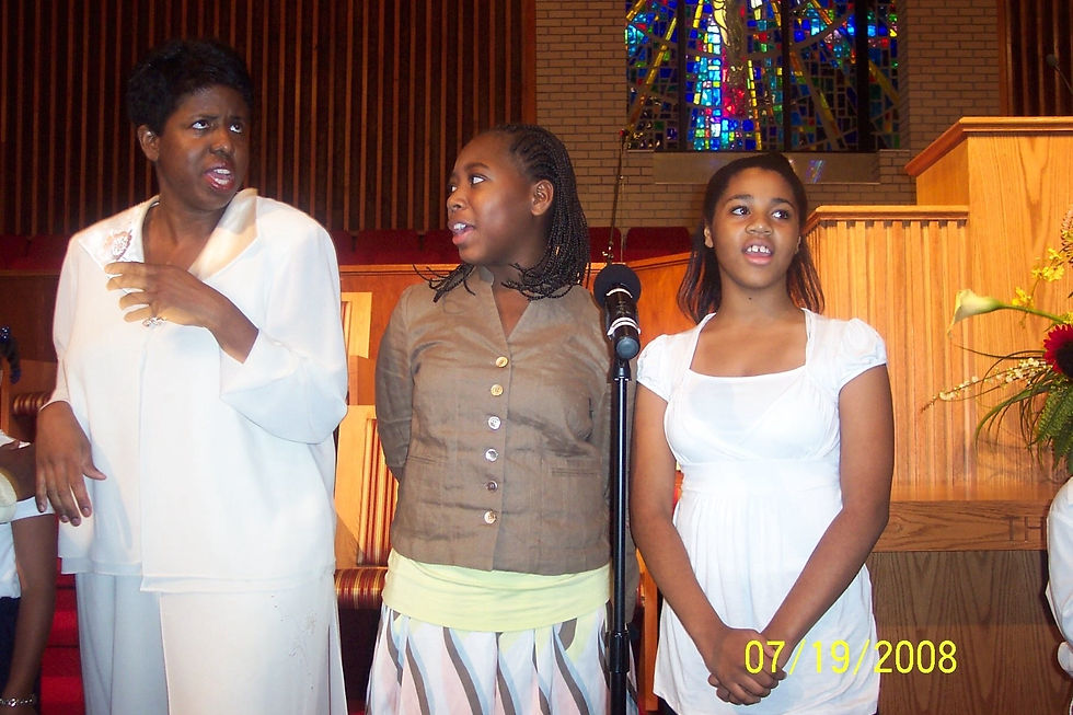 Worship leader (left), my classmate (middle), and me (right) singing on the praise team.