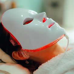 _Woman Getting Red Light Therapy for her Skin with Mask Lady using professional services i