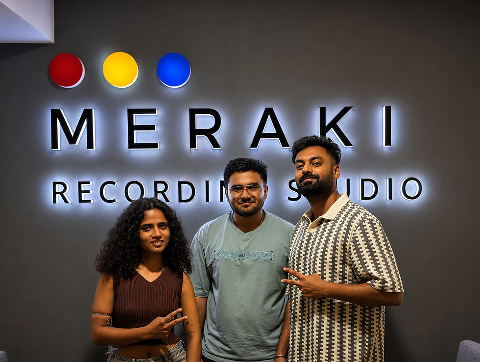 Stela Crown, Northsinc, Emcee Agranshu posing in front of a lit MERAKI RECORDING STUDIO sign, making peace signs.