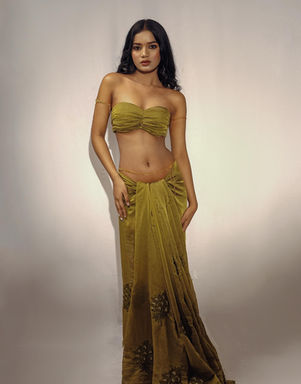 Woman in olive green outfit posing for a portrait shot with DHE Studio.