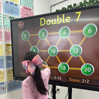 Student using interactive white board for maths